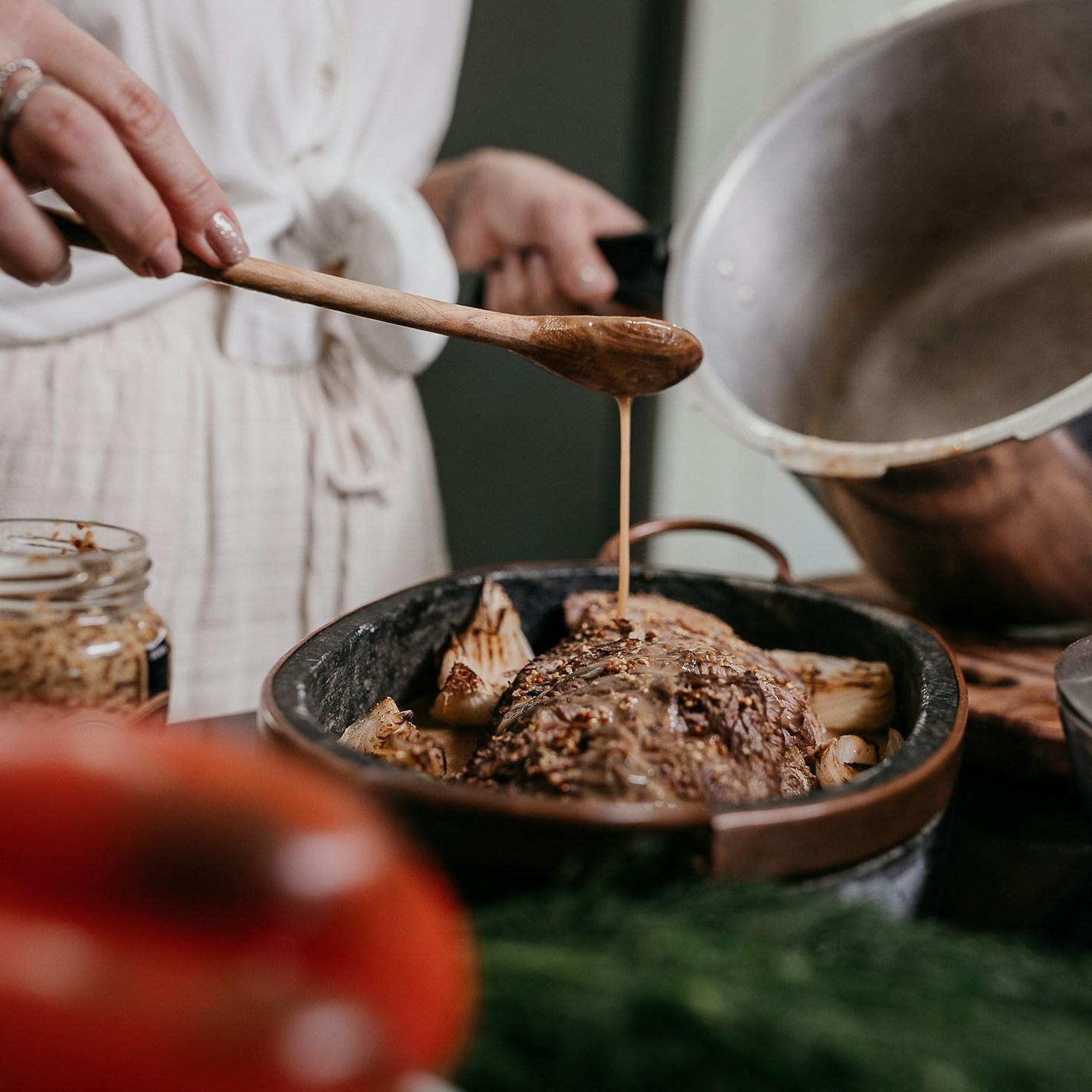 Diverse group of community members sharing a meal together, showcasing the social bonds formed through collaborative cooking